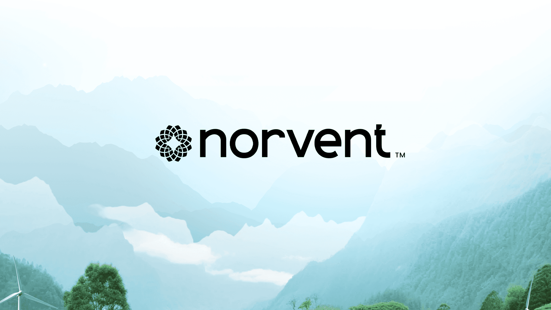 The Norvent logotype over a misted valley of onshore wind turbines