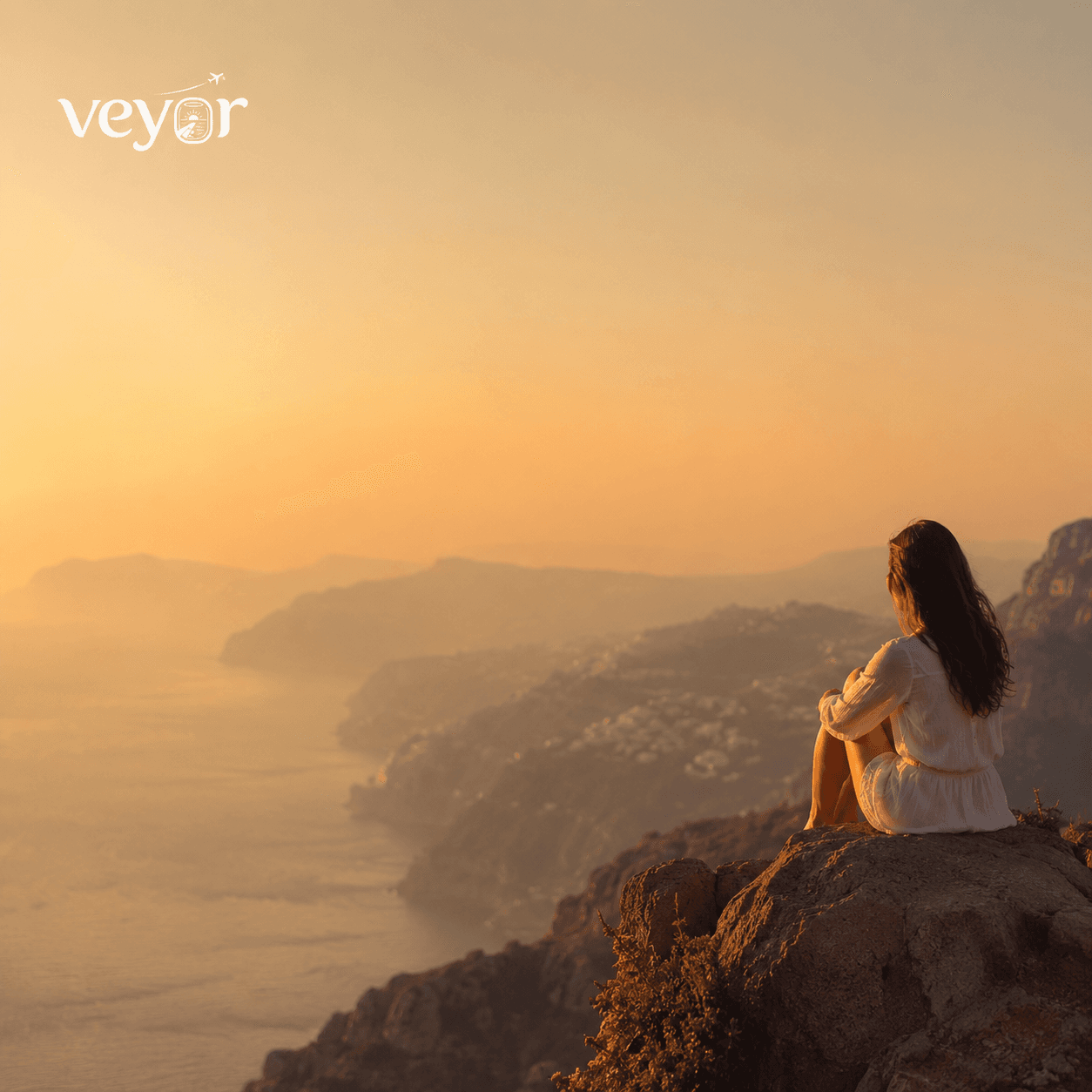 Campaign post — a traveller on a clifftop above the sea at sunset, the Veyor logotype at the top left
